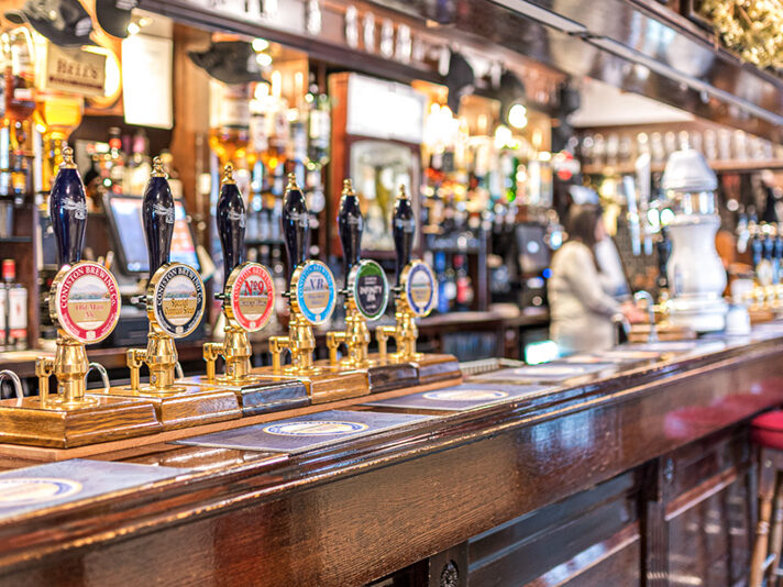 Real ale hands pulls on the bar at the Black Bull, Coniston