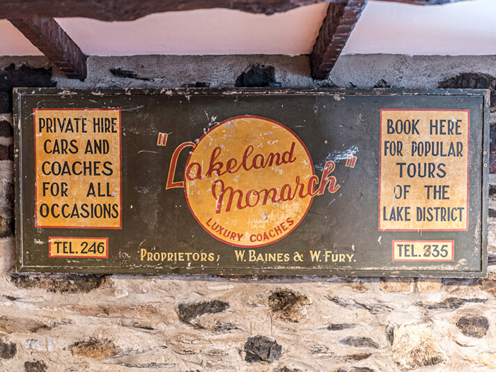 Vintage sign of Lakeland Monarch Tours at the Black Bull, Coniston