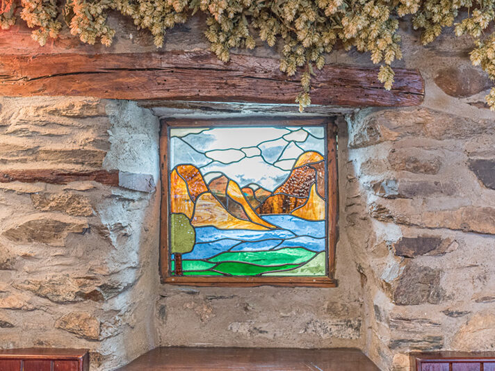 Stained glass artwork of the nearby fells and Coniston Water